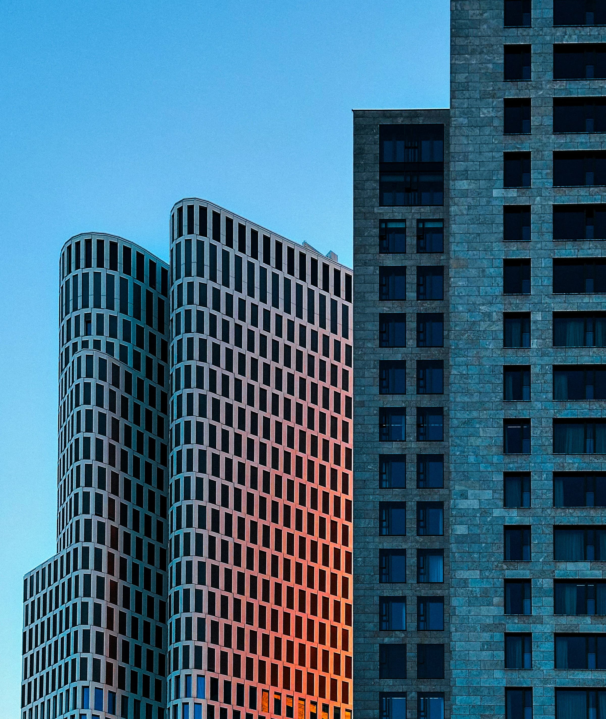 Geometric residential towers at sunset.