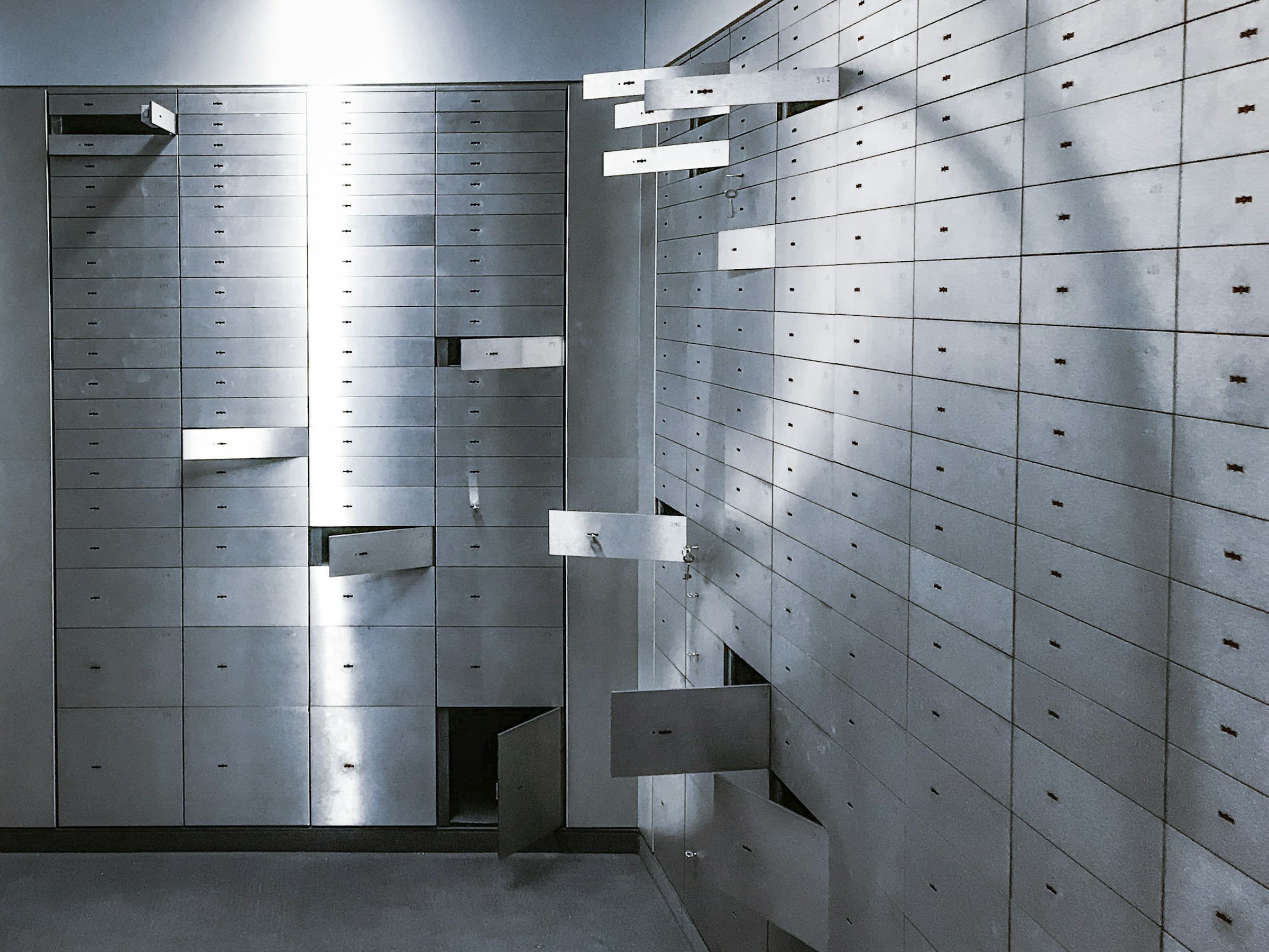 Wall of steel safe-deposit boxes in a bank vault.